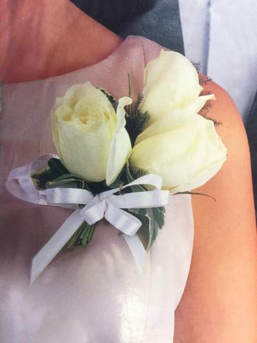 This corsage consists of three roses accented with ribbon.

Wristlet can be added
