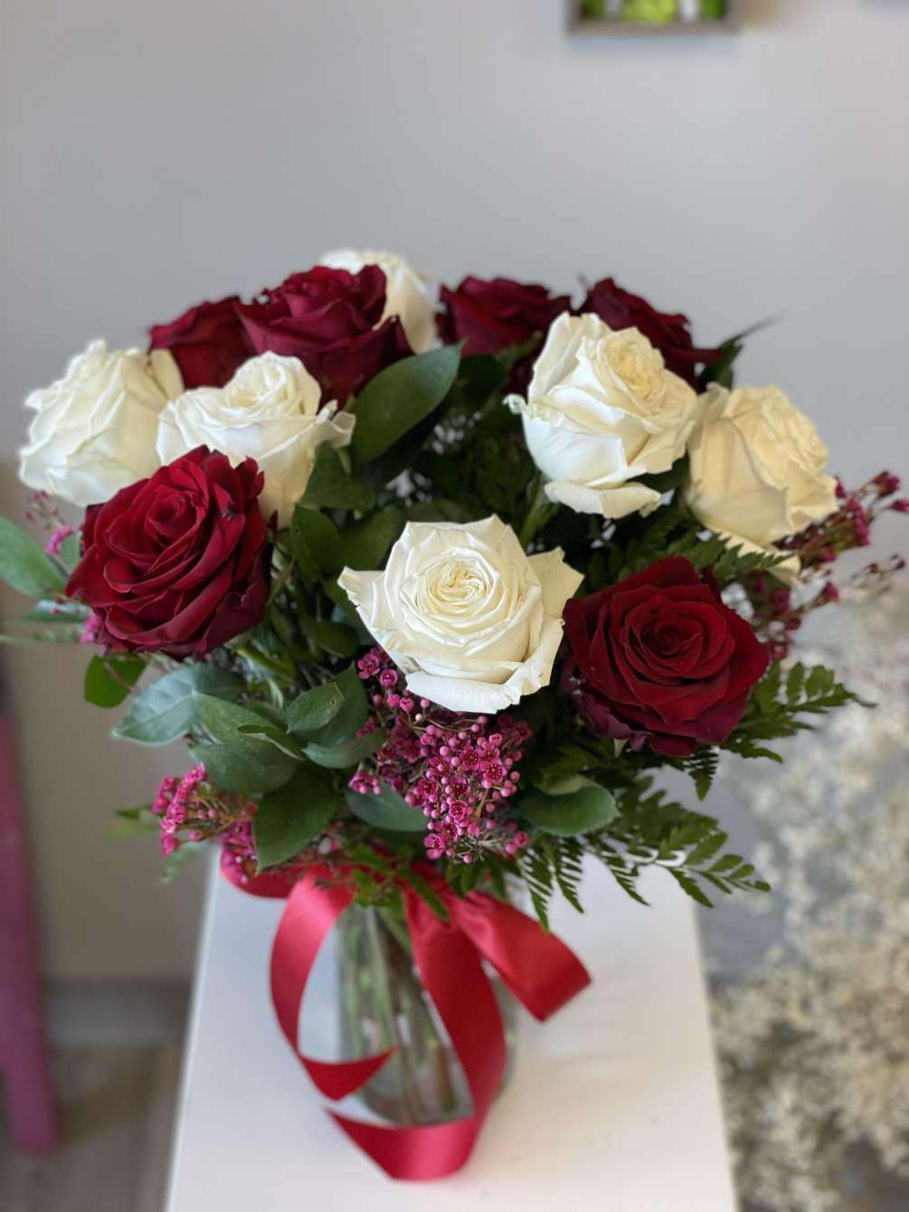 Dozen roses in a vase. Red and white. Let us know if