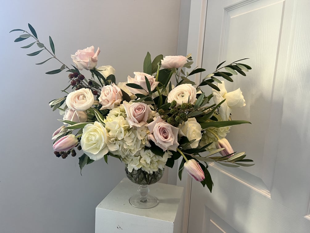 A delicate arrangement with roses, hydrangea, tulips and ranunculus.