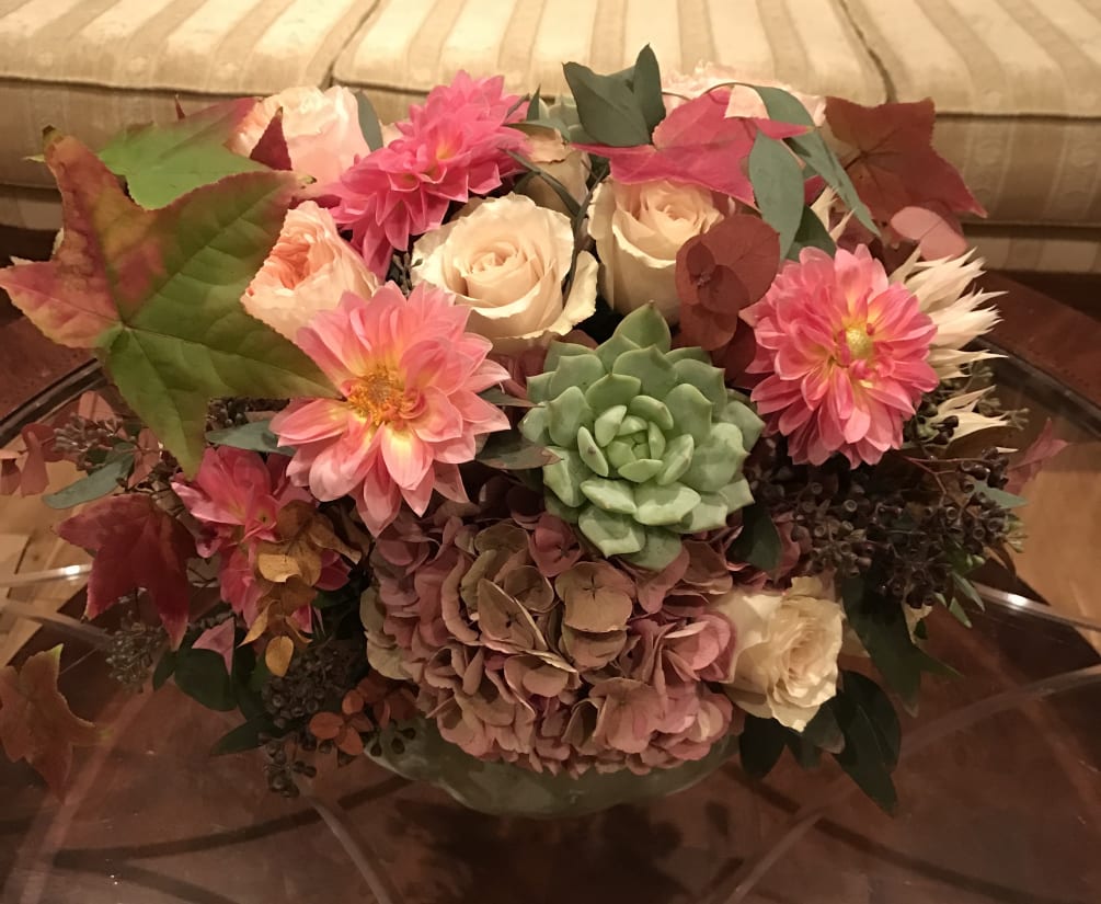 Fall arrangement in pumpkin, with roses, dahlias and succulents
