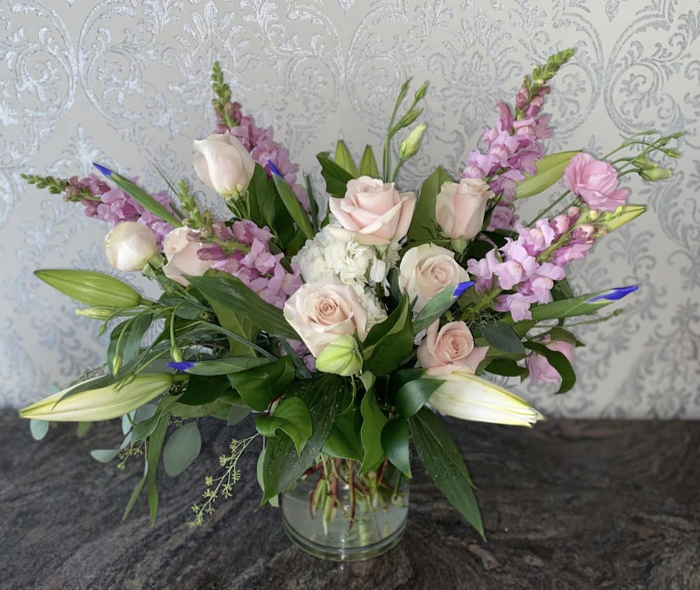Arrangement of roses, lilies, iris, snapdragons, hydrangea