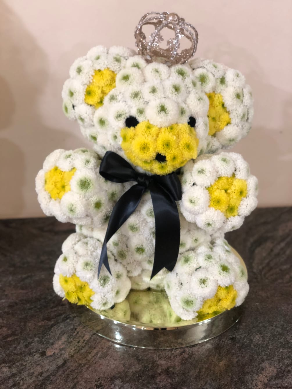 A teddy bear arrangement around 18&quot; made of button mums