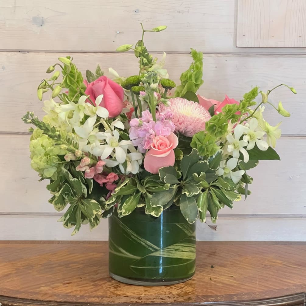 Green hydrangea, a mix of pink roses, snapdragons, chrysanthemums and stock, bells