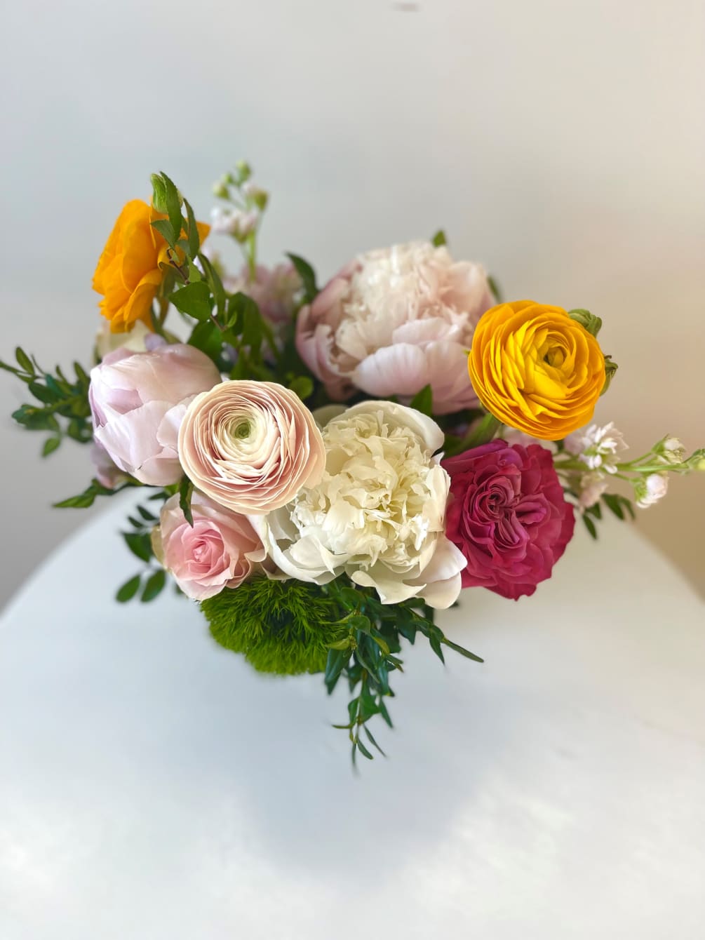 This perfect fishbowl filled with ranunculus, peonies and roses is a great