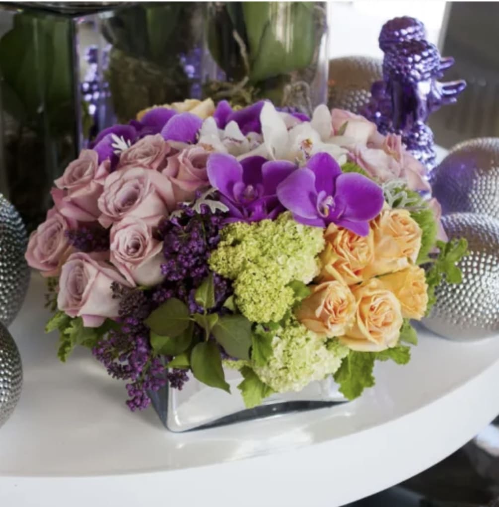Gorgeous bouquet of lilac, orchids, roses  and more stylishly arranged in