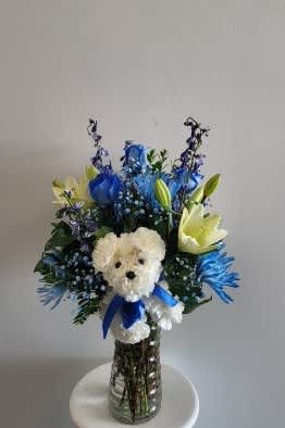 Vase arrangement with blue roses white lilies, white stock and blue belladona.