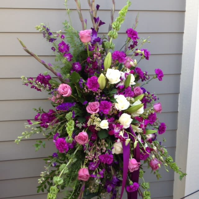 This easel spray beautifully mixes purple flowers with a white center of