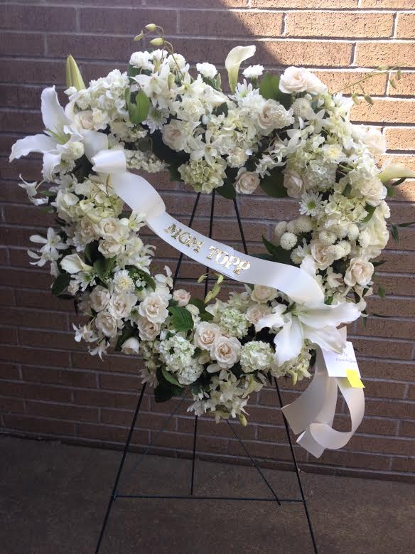 This stunning white flower wreath is a beautiful way to send your