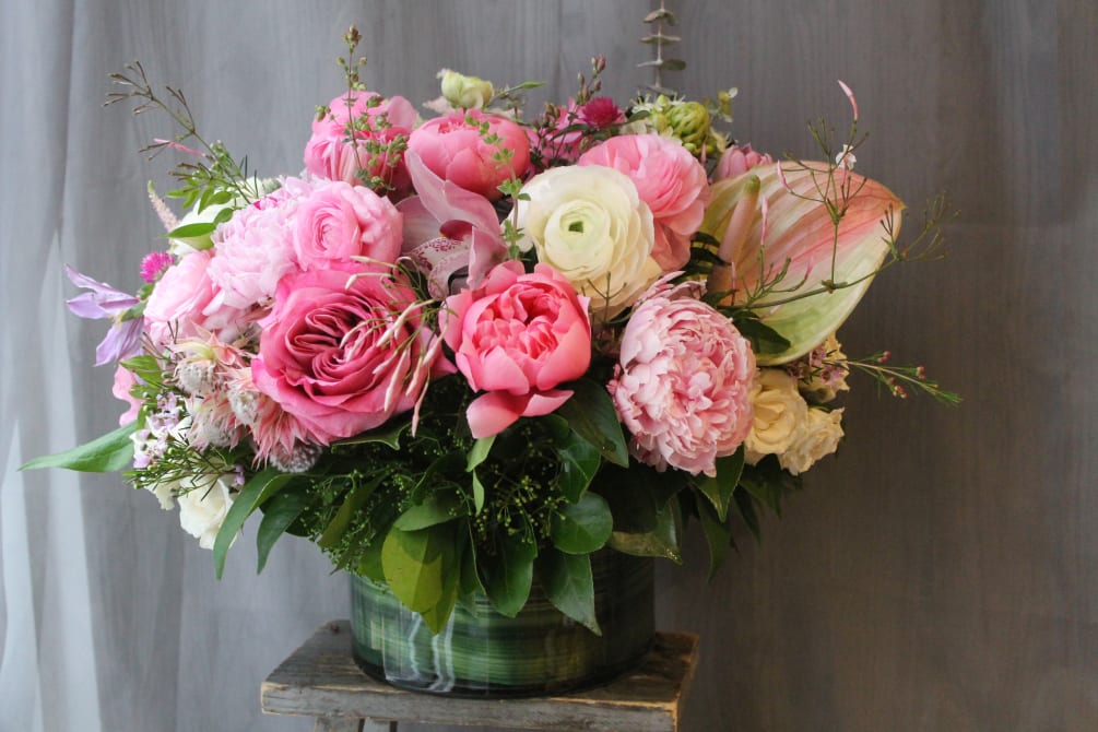 The most luxurious blooms in low clear vase. Filled with peonies, roses
