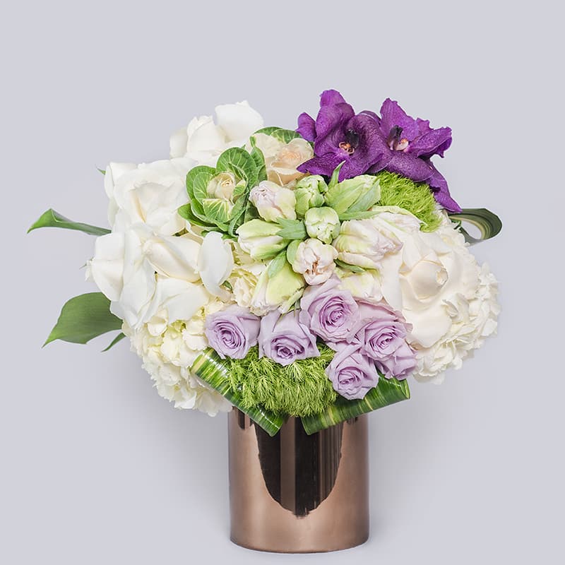 This medium sized arrangement is full of white roses and parrot tulips.