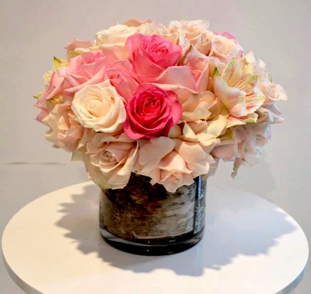 Pale pink roses with amaryllis in a wood wrapped vase! 