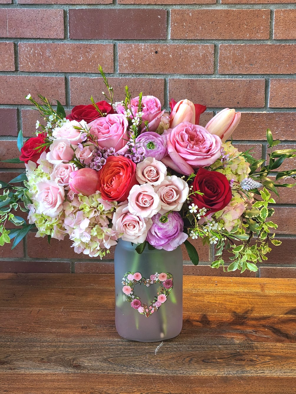 Large vase with a Heart of flowers filled with pink hydrangeas, roses