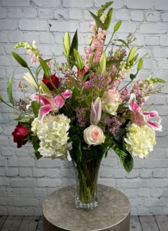 This arrangement of pink and white tones is full of lush roses
