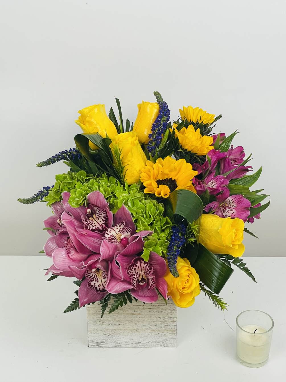 Beautiful arrangement with cymbidium orchid ,sunflowers , roses 