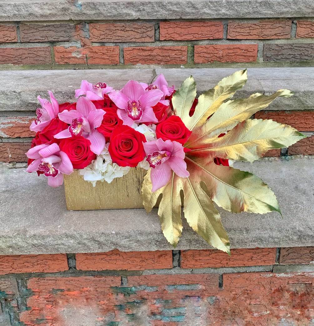 Looking to make a great impression? This luxe arrangement with Cymbidium Orchids