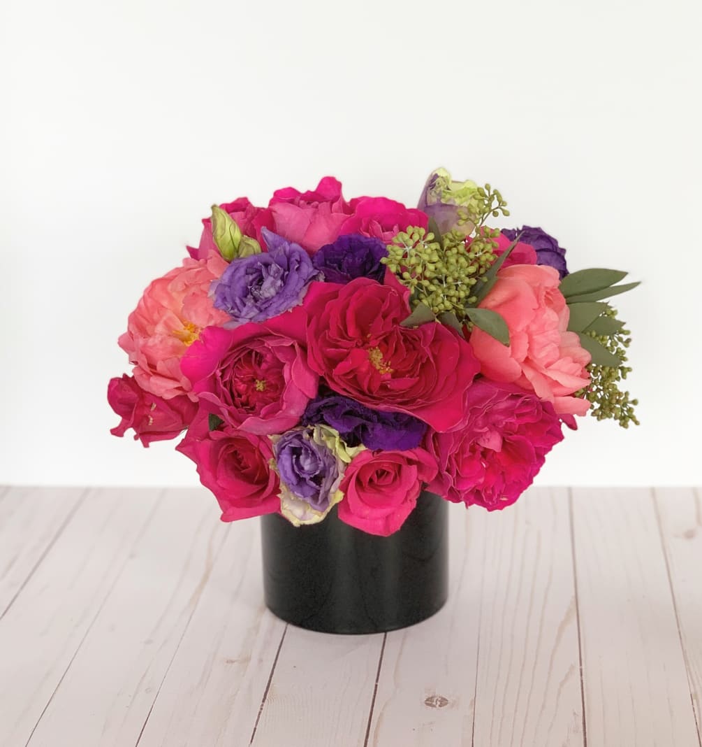 An eye-catching display of mixed spring floral in rich bold color tones.