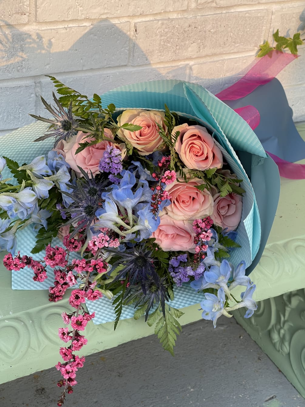 this beautiful hand held bouquet is wrapped in korean wrap paper and