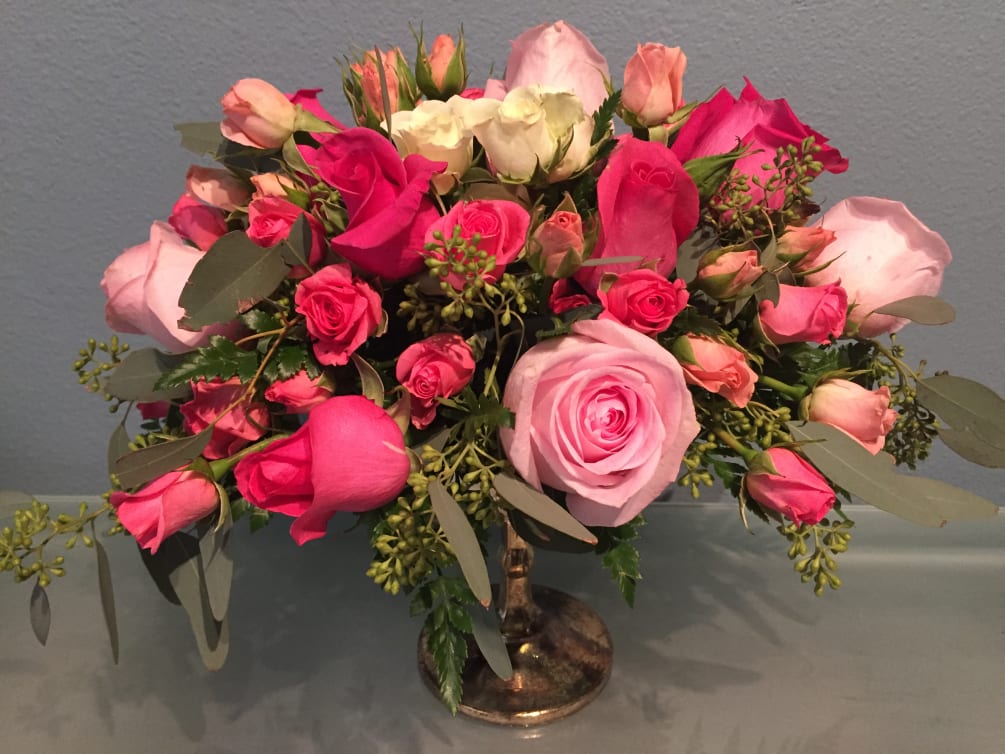 This stunning bouquet of pink roses beautifully arranged in a classic mercury