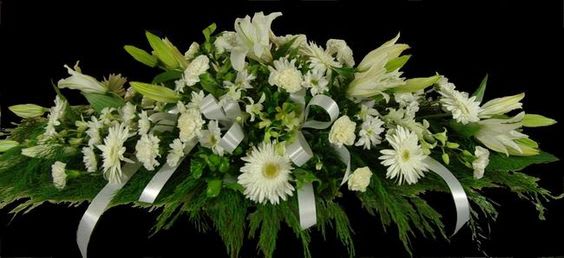 A mix of white flowers as shown for the casket
