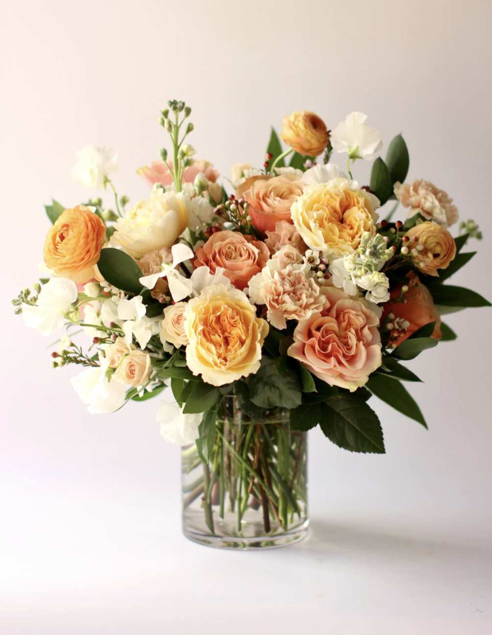 A variety of peach and cream premium and seasonal blooms- hand-picked by
