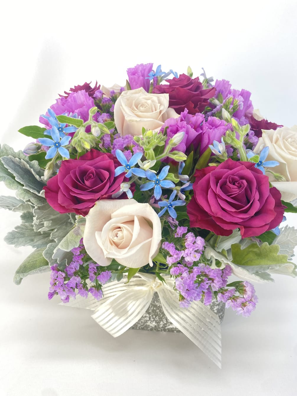 Colorful and sophisticated floral arrangement in a nice concert vase.