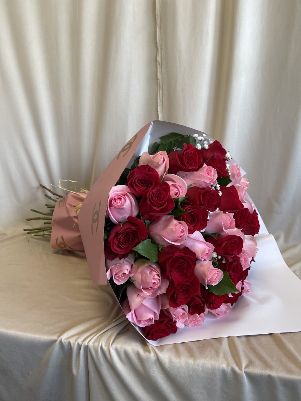 50 pink and red roses mixed with Chanel wrapping 