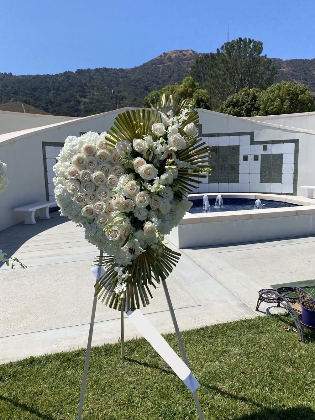 An all white tribute, this white Heart funeral spray is pure and