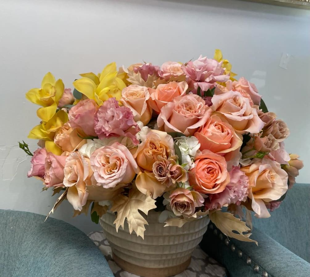 Orange and nude tones roses and yellow orchids