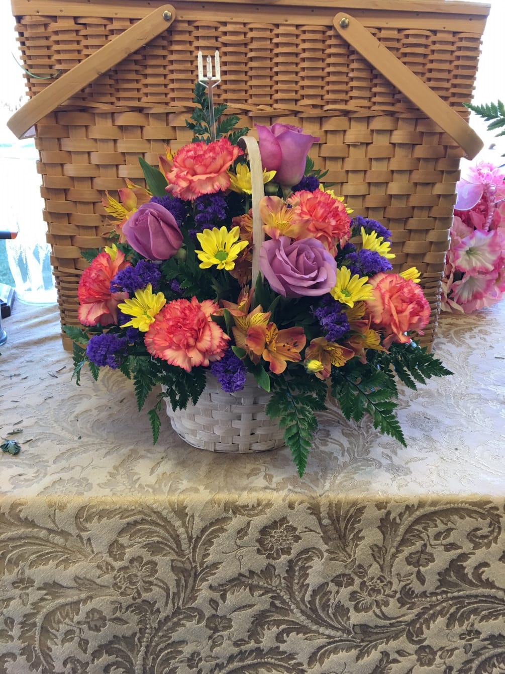 Sending cheer is easy with our bright colorful basket of blooms. Roses