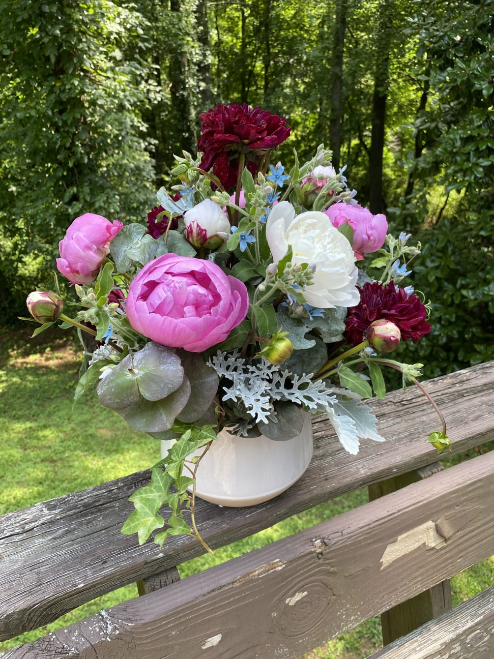 Cascade of full and fragrant flowers in an arrangement. Accented with texture