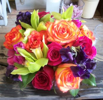 This jewel tone medley is layered with hydrangea, roses, sweet peas, and