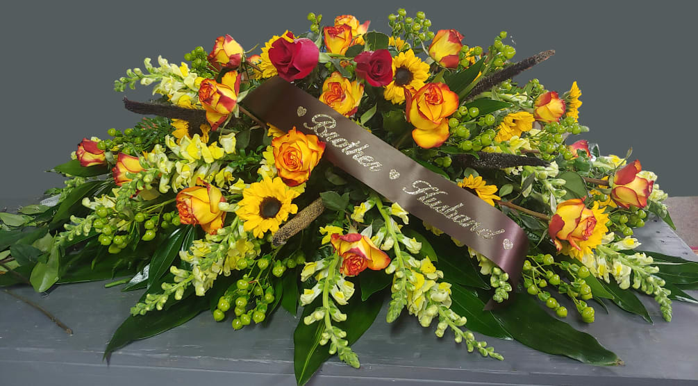 Beautifull fall colored casket spray. Ribbons not included.