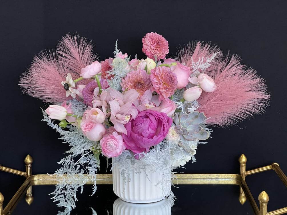 A whimsical combination of pink blooms and silver, accented with pink pampas