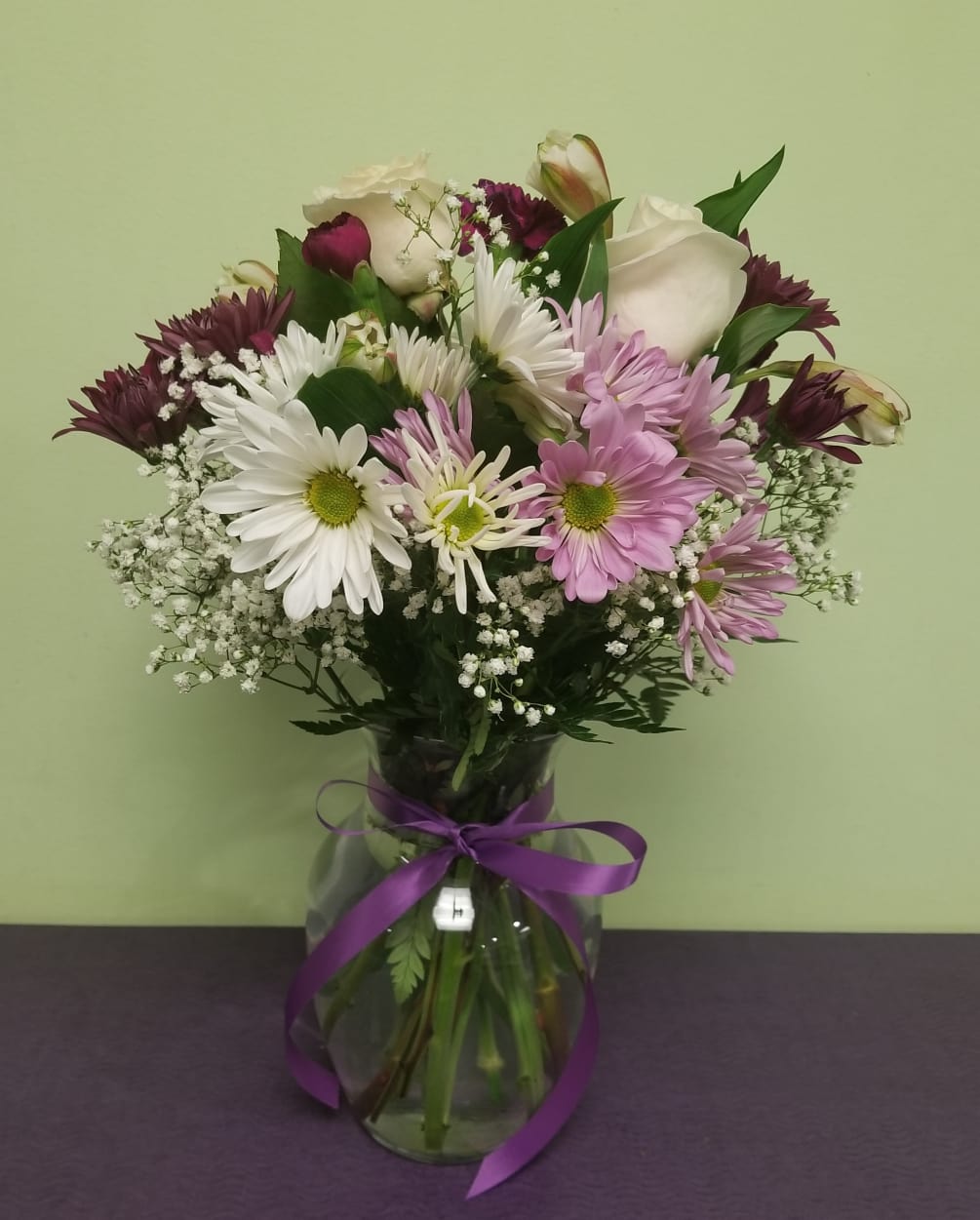 This is a special arrangement with hints of purple, lavender, and whites.