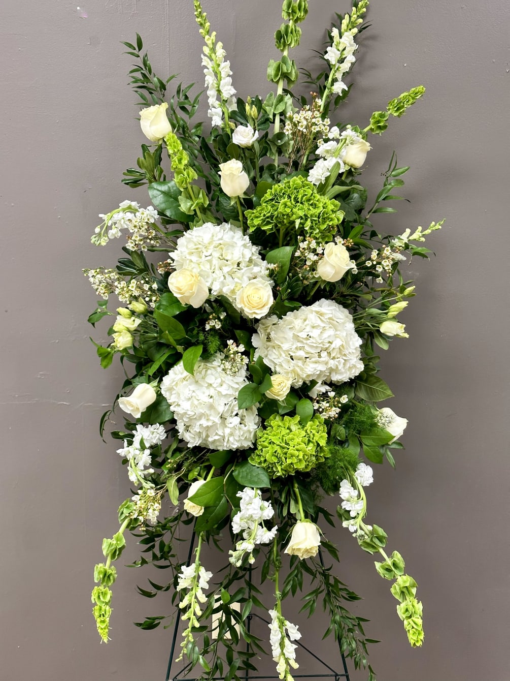 This heartfelt presentation showcases striking seasonal blooms with unique textural flowers. Customize