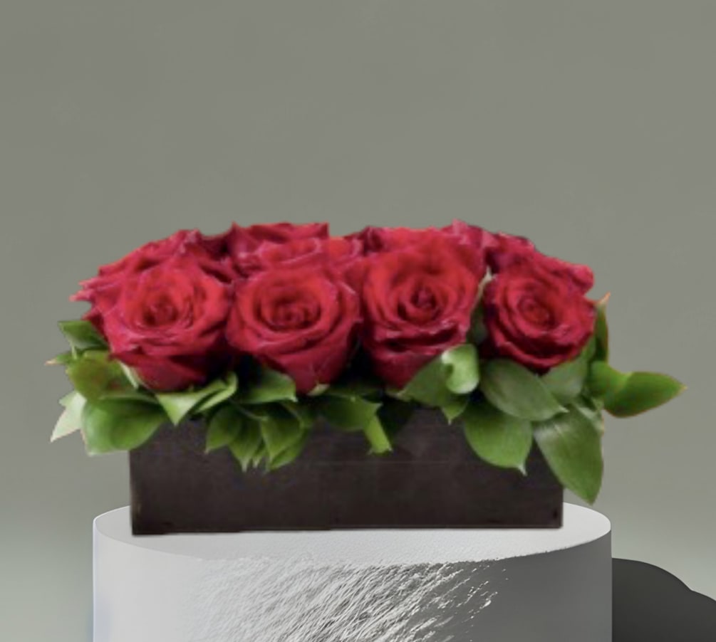 Red roses and foliage in a low wooden box. Standard- 1 dozen