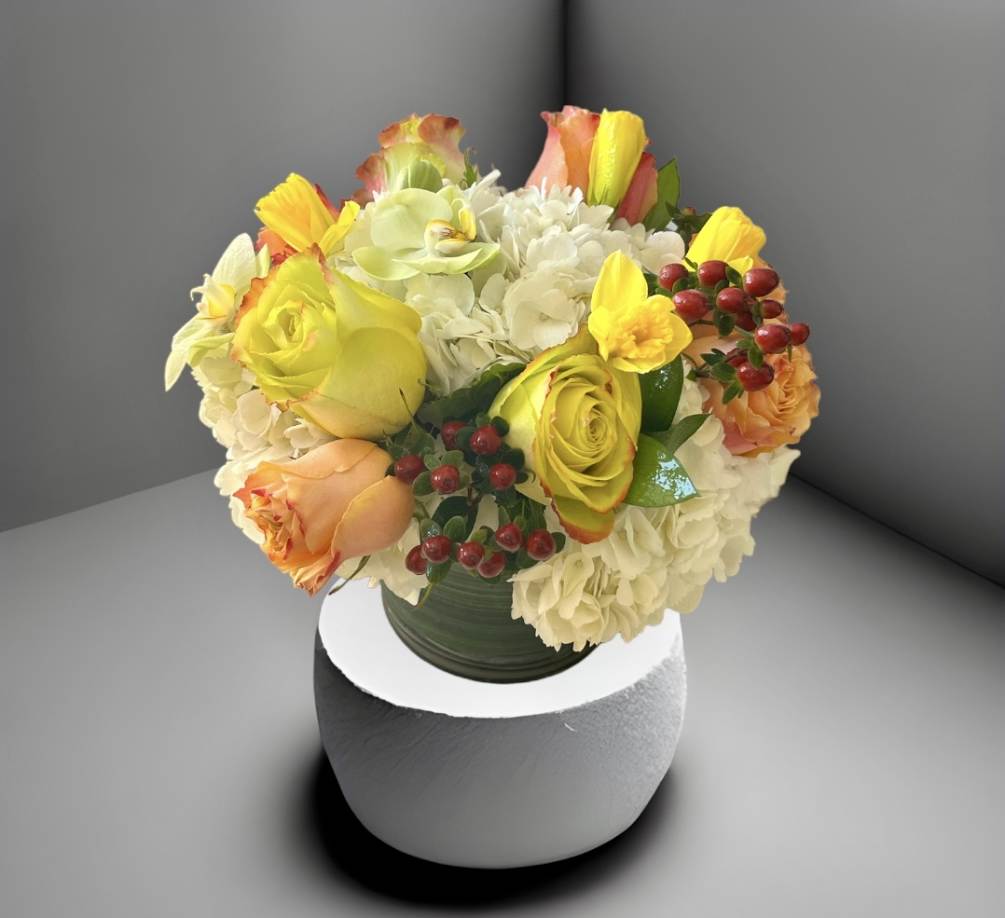 A bright cheerful mix of hydrangea, colorful roses, and seasonal flowers and