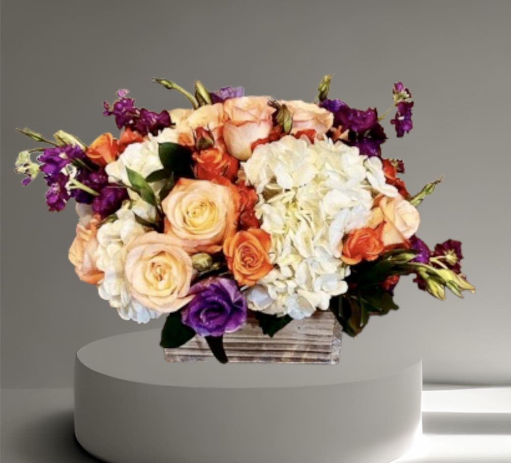 A lovely seasonal mix of roses, hydrangea, and other seasonal flowers and