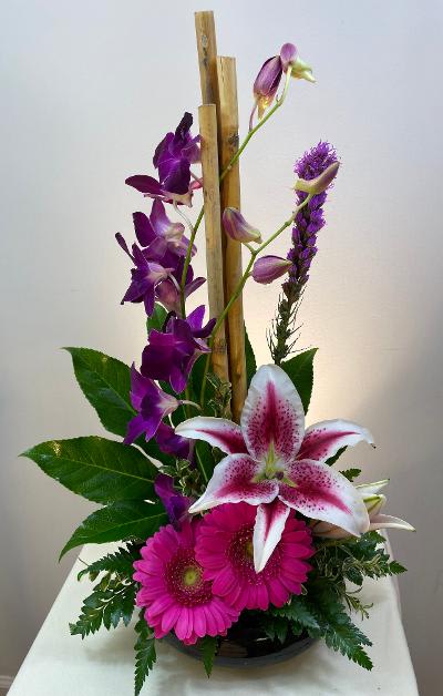 Dendrobium orchids with river cane aid lilies create a dramatic impression!