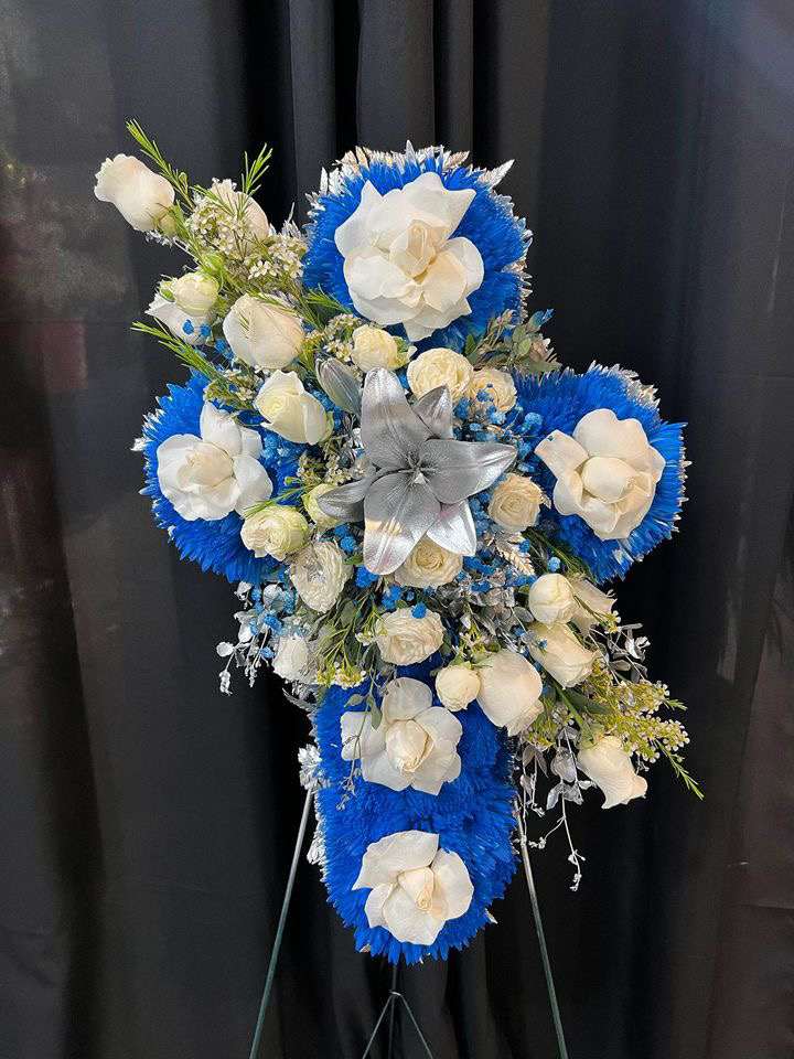 White and blue flower cross comes with roses,cushion,and lilies 