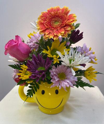 Bright mixed flowers in our popular Smiley mug. A cheerful everyday gift
