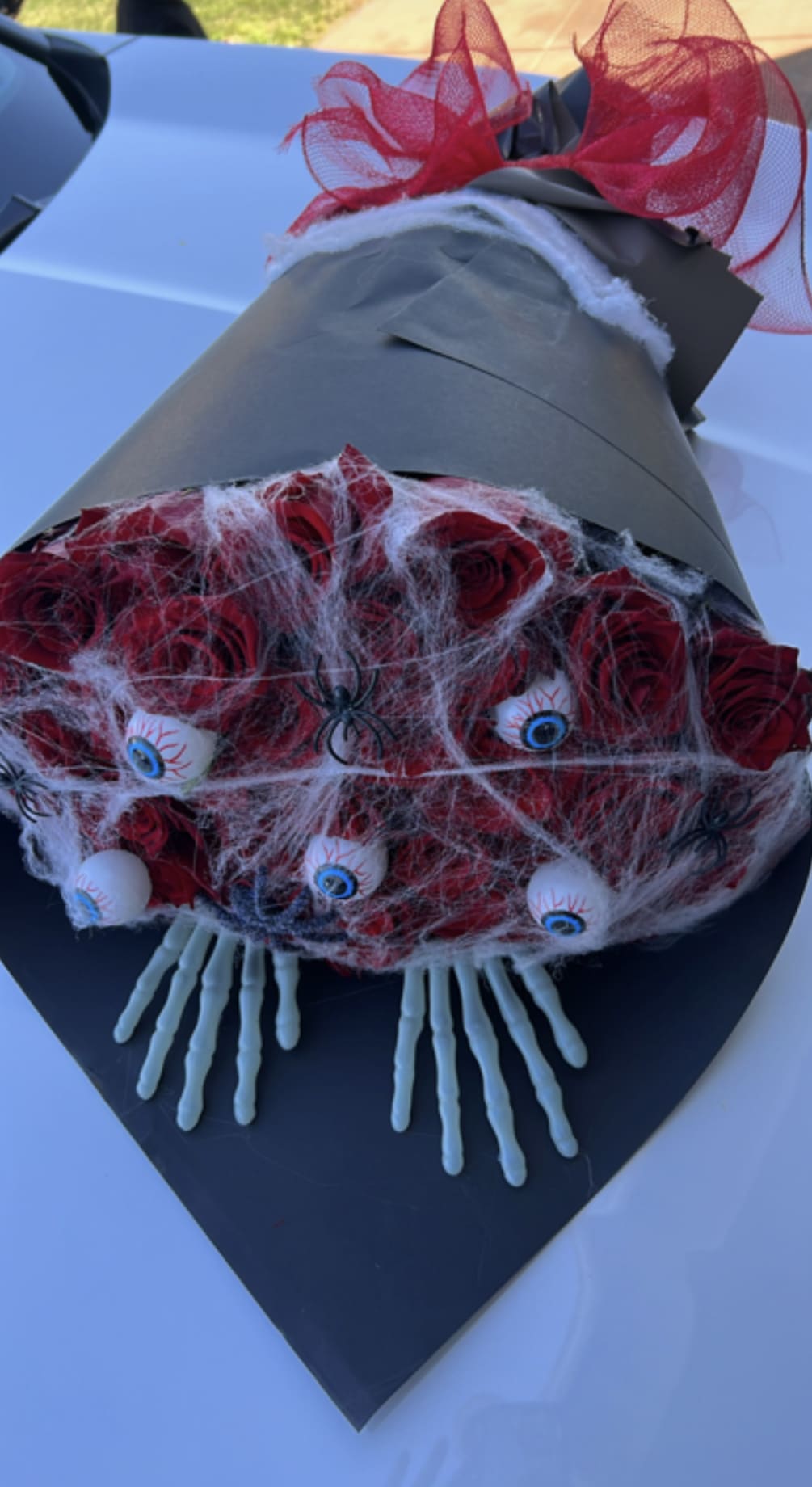 Spooky red roses bouquet comes with 50red roses and spooky skeletons hands
