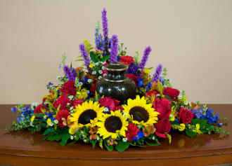 Cremation Urn spray of sunflowers &amp; other bright colored flowers.

*Please notify florist