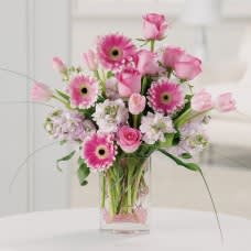 Sweet pink roses, Gerbera daisies and tulips are sure to delight the