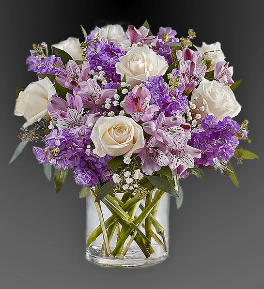 Cr&egrave;me roses, purple carnations, miniature light pink carnations, lavender cushion spray chrysanthemums