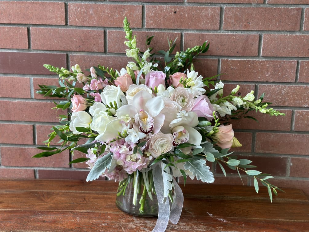 Clear Modern Vase Filled with White Snap Dragons, White Orchids, Peach Lisianthus