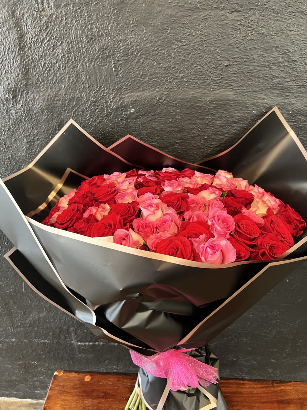 black wrapping and roses by Flower Studio San Diego