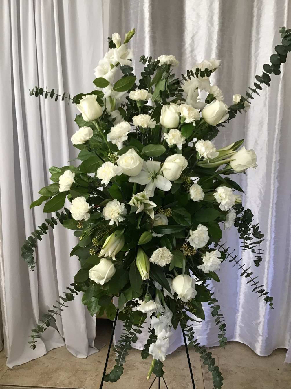 Beautiful white roses/lilies, carnations and greenery.  