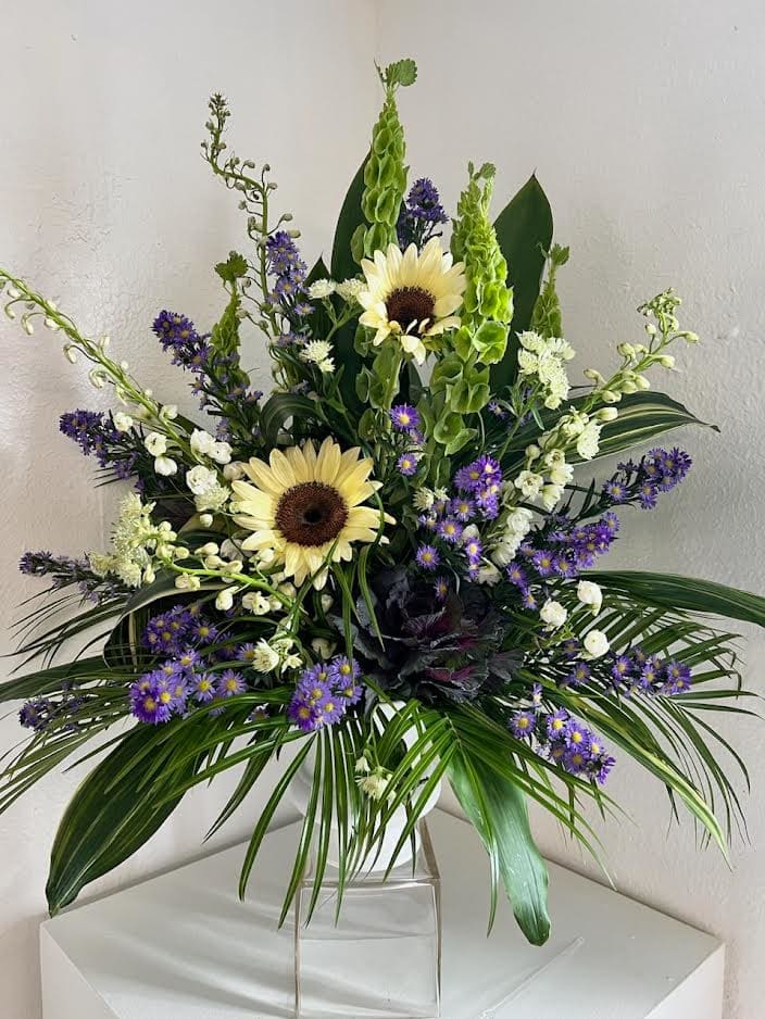Seasonal white sunflowers mixed with an assortment of purples and cream flowers