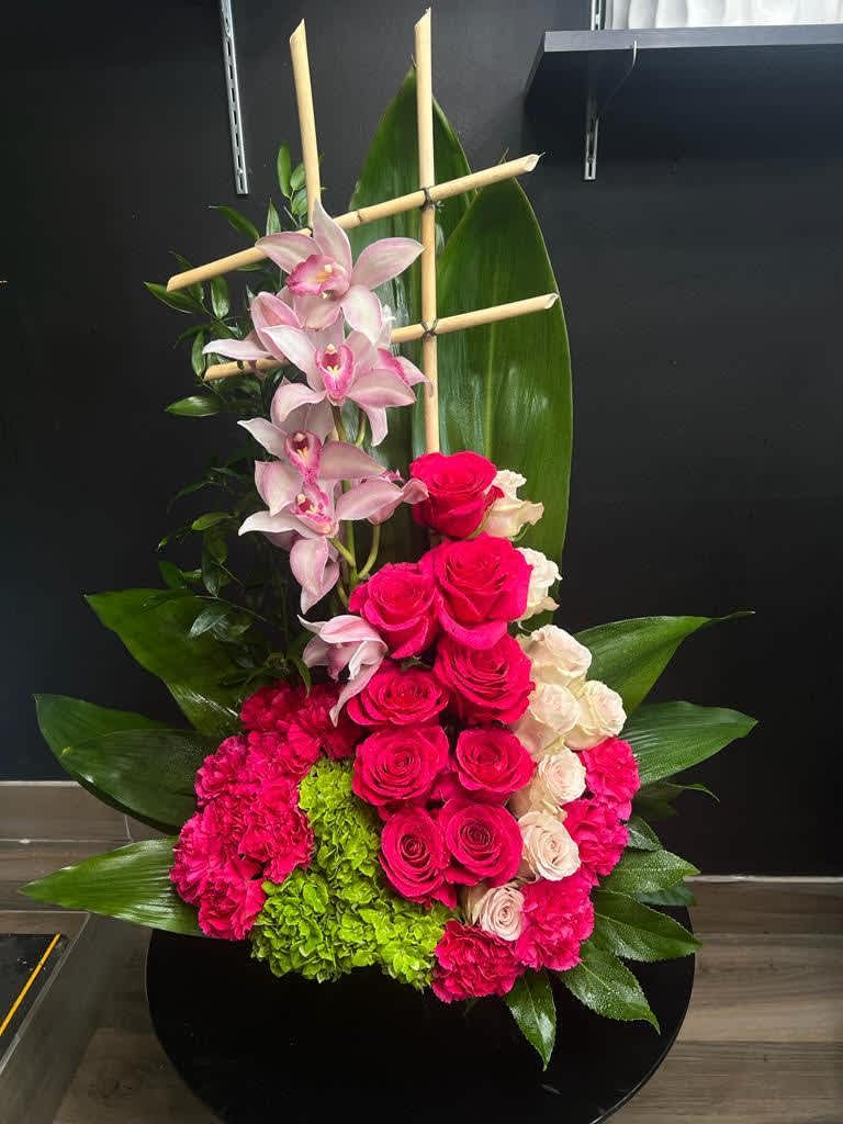 Cymbidium orchids, roses, carnations and hydrangeas and greenery